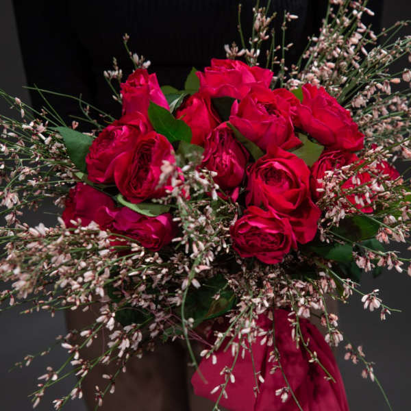 Bouquet of red roses with pink filler flowers and ribbon