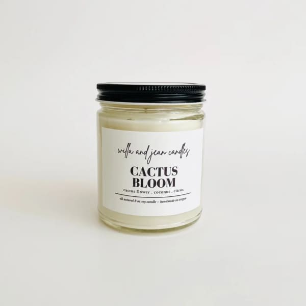 Jar candle with a black lid and white label reading Cactus Bloom