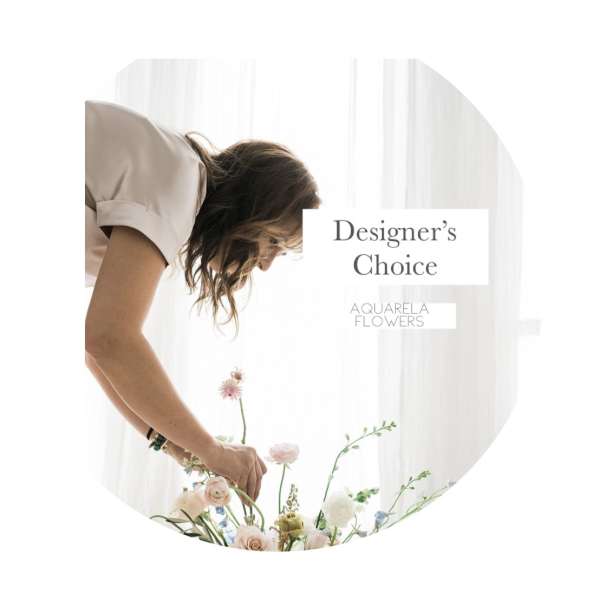 Woman arranging a pastel flower bouquet with "Designer’s Choice" text