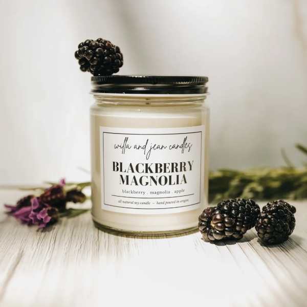 Blackberry Magnolia candle in a glass jar with blackberry decorations