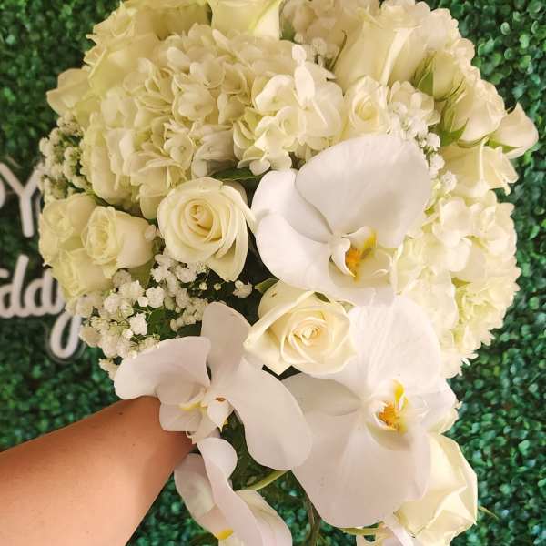 White bouquet with roses, hydrangeas, and orchids