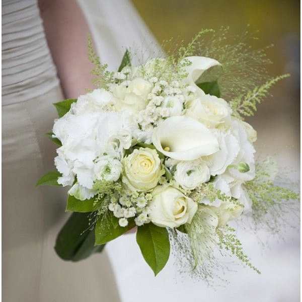 Bridal hand-tied bouquet of white roses, calla lilies, and soft ivory blooms.