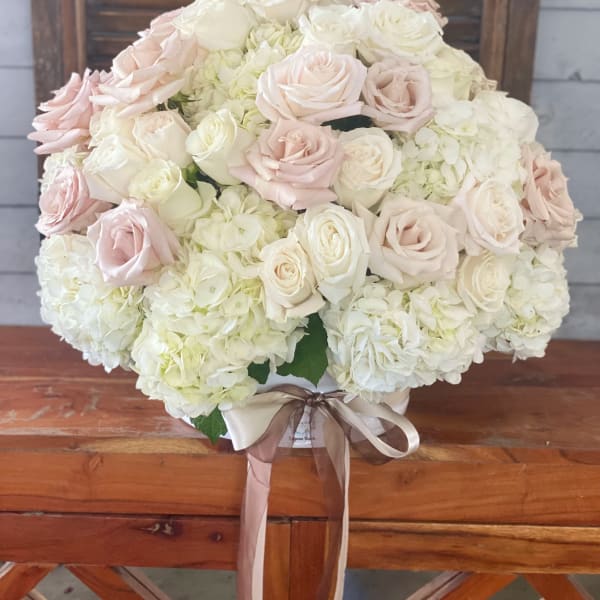Large bouquet of pale pink and white roses with white hydrangeas