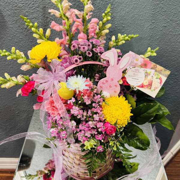 Pink and yellow flower basket with a pink bunny decoration