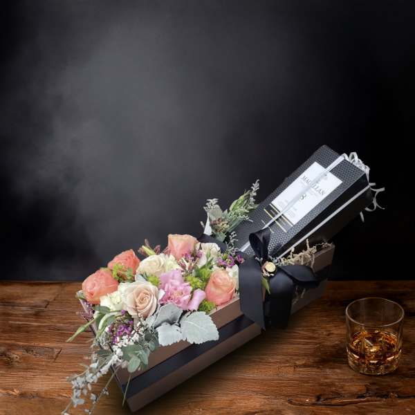 Boxed bouquet of pastel roses and mixed flowers with a ribbon