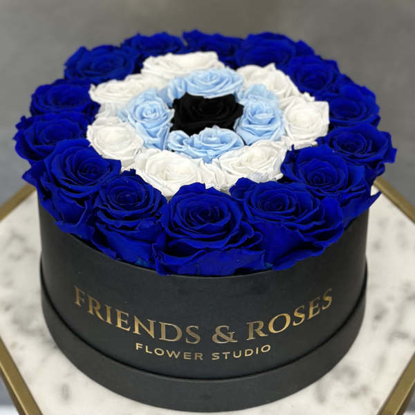 Round box of blue, white, and light blue roses with a black center rose