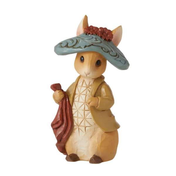 Decorative rabbit figurine wearing a blue hat and holding a red cloth