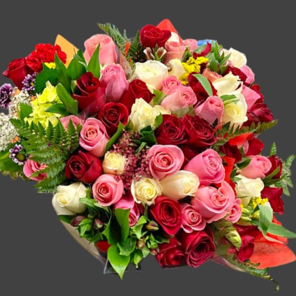 Large bouquet of red, pink, and white roses with mixed filler flowers