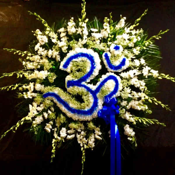 White floral wreath with a blue number 30 and ribbon