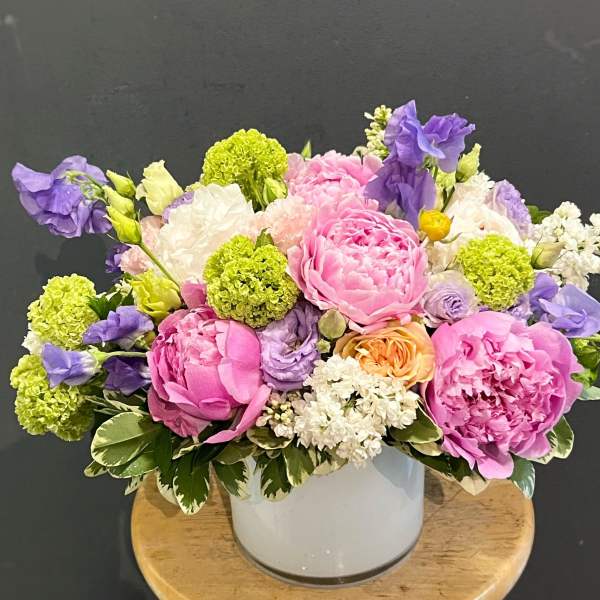 Pink and purple bouquet in a white vase