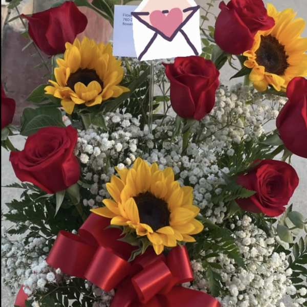 Bouquet of red roses and sunflowers with a red ribbon