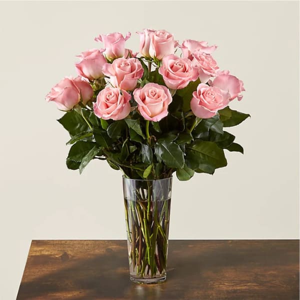 Pink roses arranged in a clear glass vase