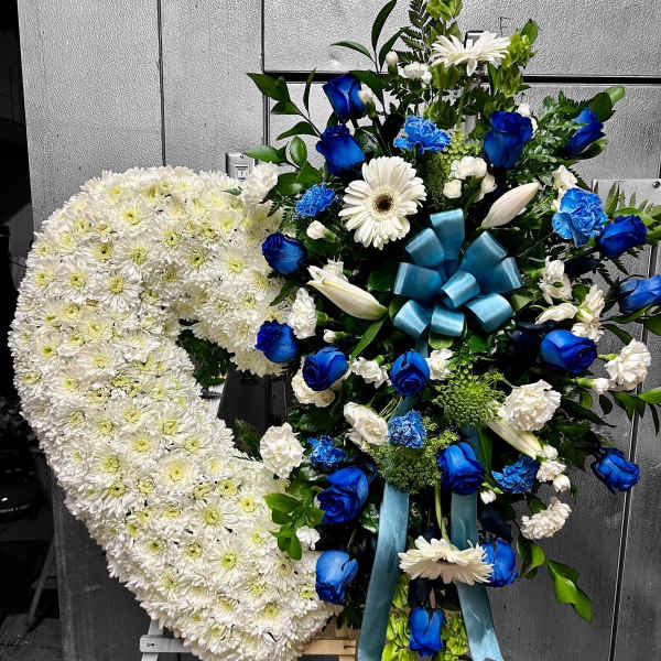 Standing sympathy easel with a white chrysanthemum heart and blue and white floral spray.