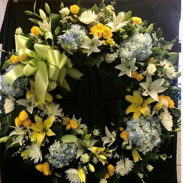 Large floral wreath with yellow, white, and blue flowers