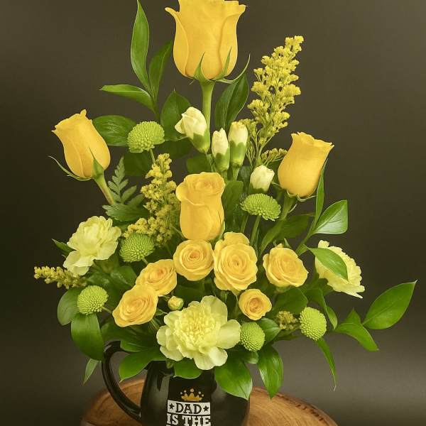 Yellow and green floral arrangement in a black “Dad is the King” mug on a wooden slab base