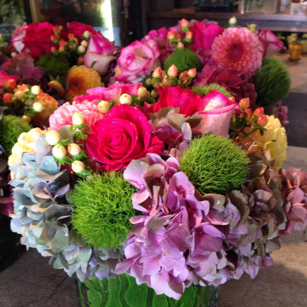 Pink and purple floral arrangement in a glass vase