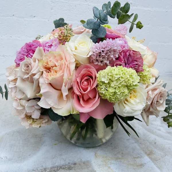 Mixed pink and white roses in a glass vase