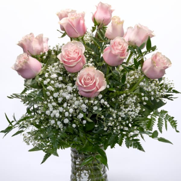 Pink roses and baby's breath in a clear glass vase