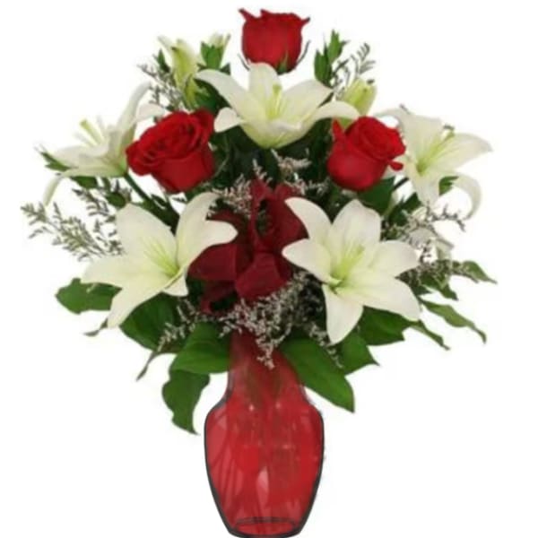 Red roses and white lilies in a red glass vase