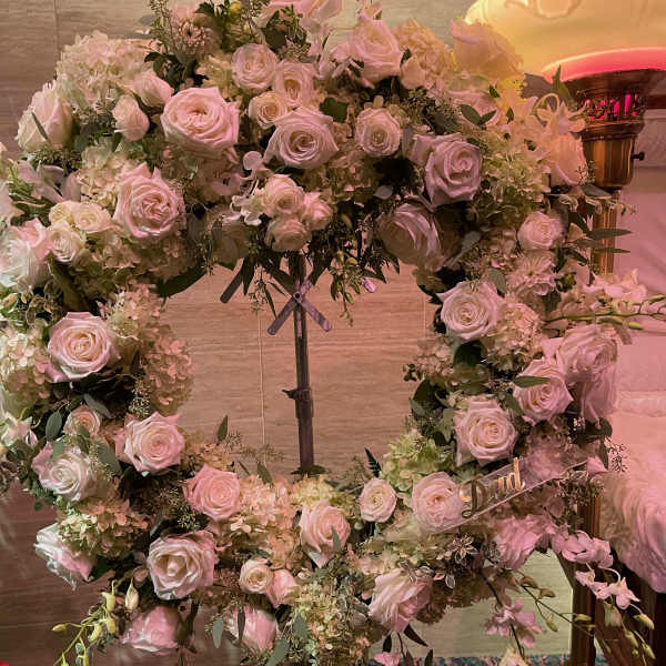 Heart-shaped floral wreath of pale pink and white roses