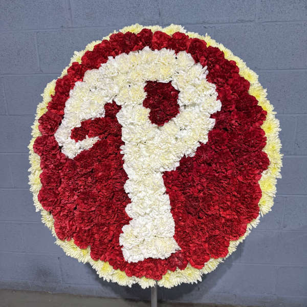 Round red and white floral wreath on a stand