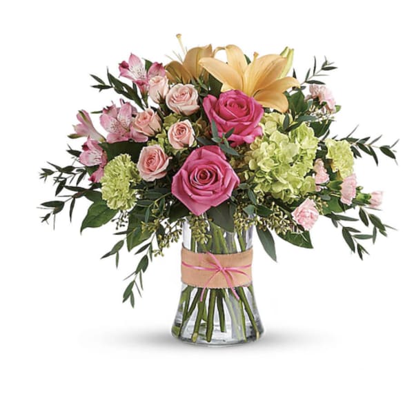 Bouquet of pink and yellow flowers in a glass vase