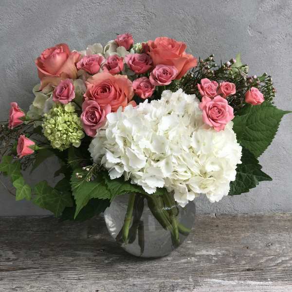 Pink roses and white hydrangeas in a glass vase
