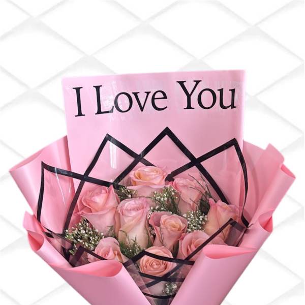 Pink rose bouquet wrapped with a "I Love You" card and black ribbon