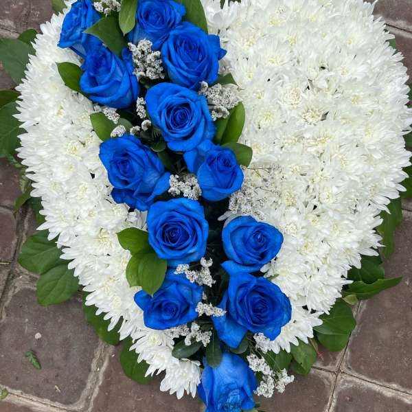 Heart-shaped bouquet of blue roses and white chrysanthemums