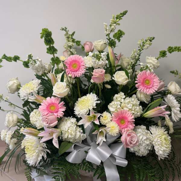Large bouquet of pink and white flowers with a silver ribbon