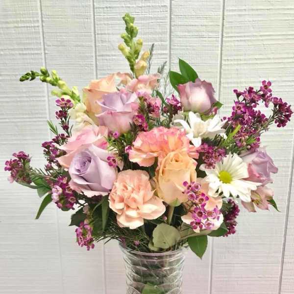 Pastel mixed flower bouquet in a clear glass vase