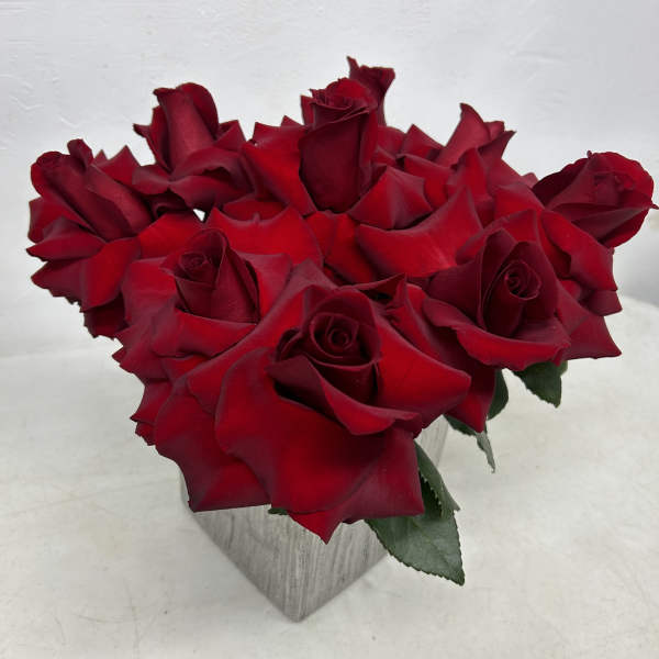 Bouquet of red roses in a square vase