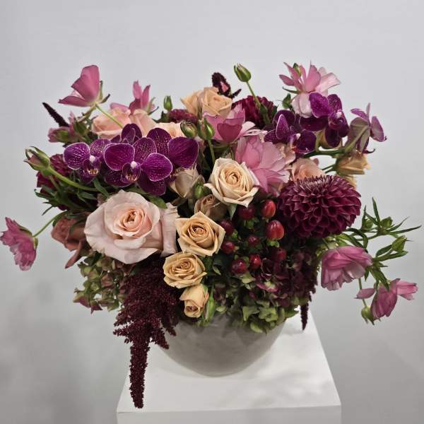 Bouquet of pink and purple flowers in a white vase