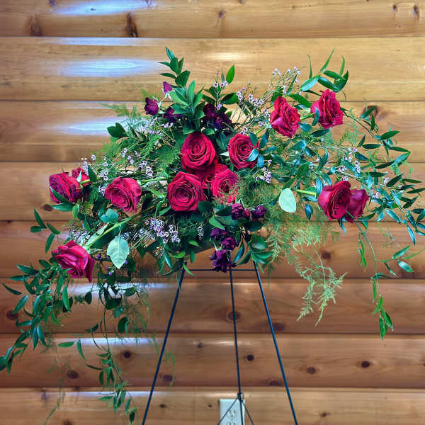 Cascade bouquet of hot pink roses with greenery on a stand