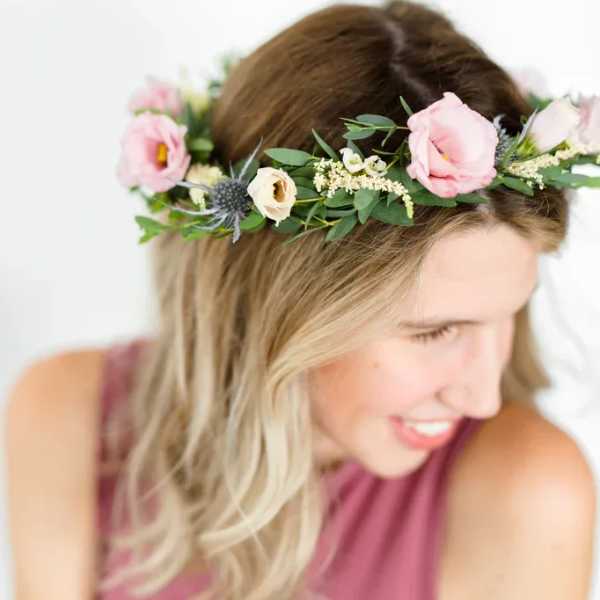 Woman wearing a pink floral crown with small blossoms