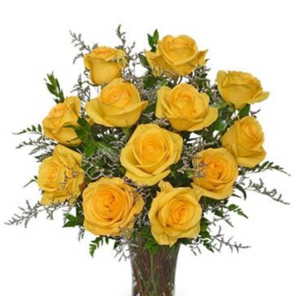 Yellow roses arranged in a clear glass vase