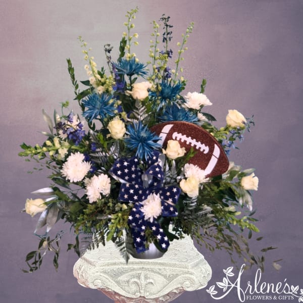 Football-themed floral arrangement with blue and white flowers in a vase