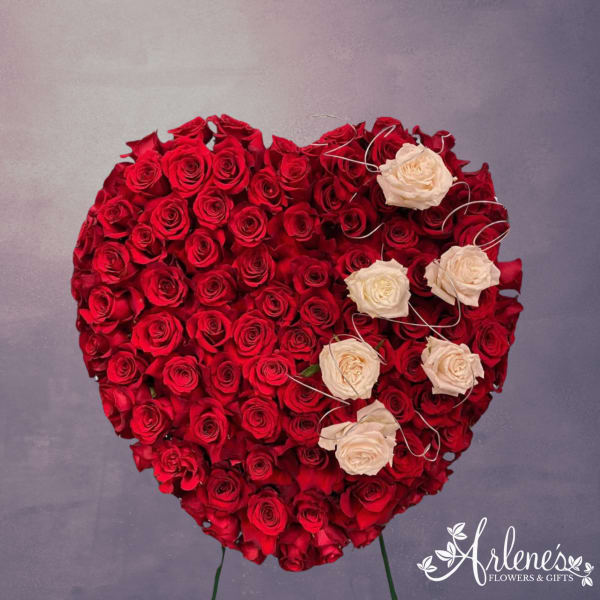 Heart-shaped arrangement of red and white roses