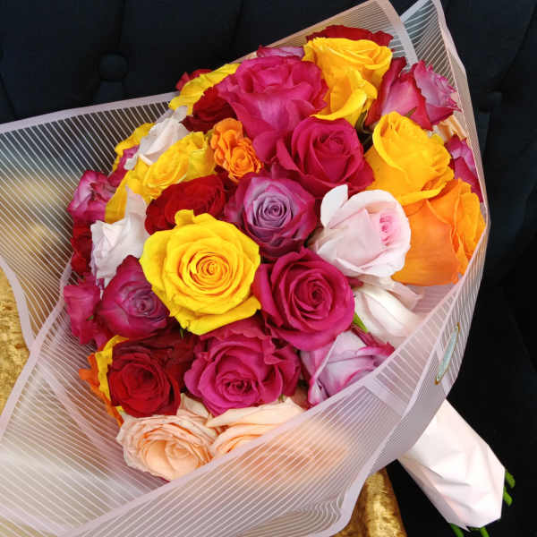 Bouquet of multicolored roses wrapped in striped paper