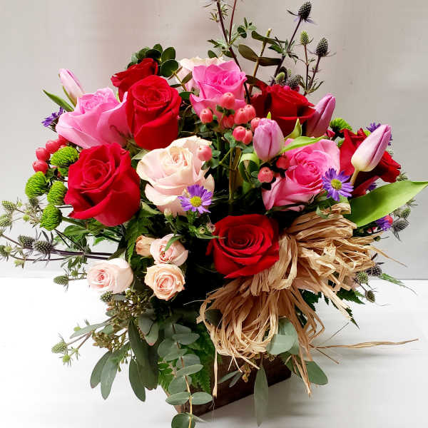 Mixed bouquet of red and pink roses with small purple flowers