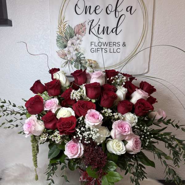 Large bouquet of red, pink, and white roses with baby's breath