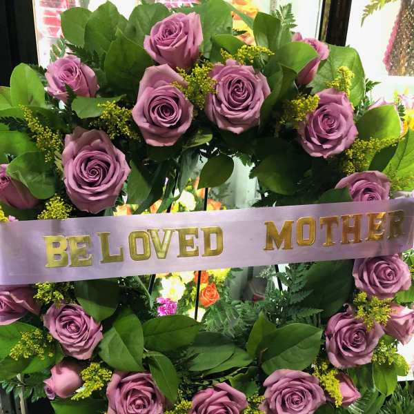 Lavender rose wreath with a "Be Loved Mother" ribbon