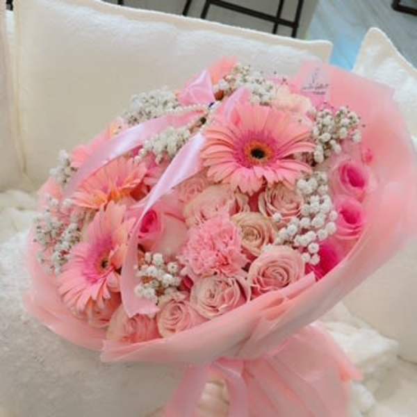 Pink bouquet with gerbera daisies and roses wrapped in pink paper