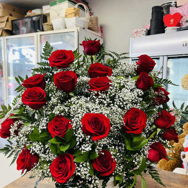 Basket arrangement of red roses with white filler flowers