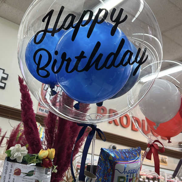 Clear balloon with blue balloons and "Happy Birthday" text