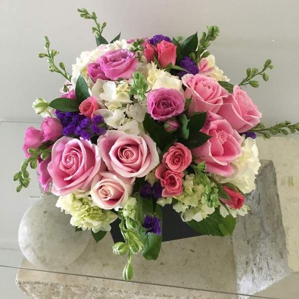 Bouquet of pink and white roses with purple accents