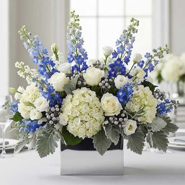 White and blue floral arrangement in a square box