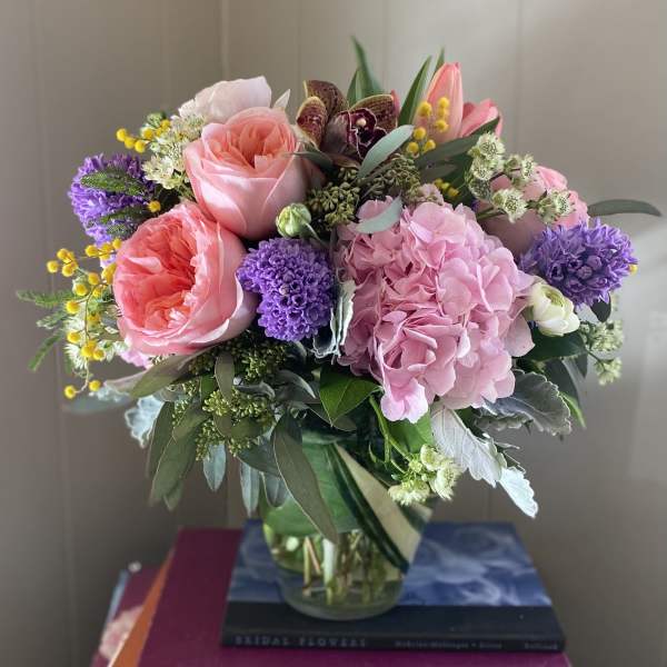 Bouquet of pink and purple flowers in a glass vase