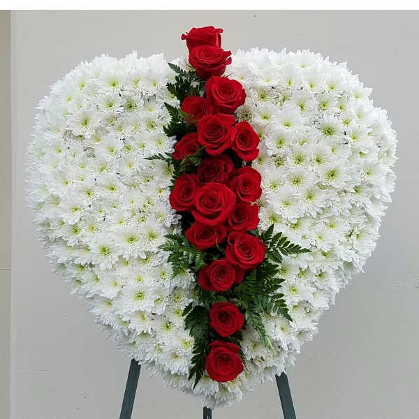 Heart-shaped white chrysanthemum wreath with a vertical line of red roses
