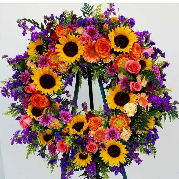 Large standing wreath of sunflowers, roses, and purple flowers